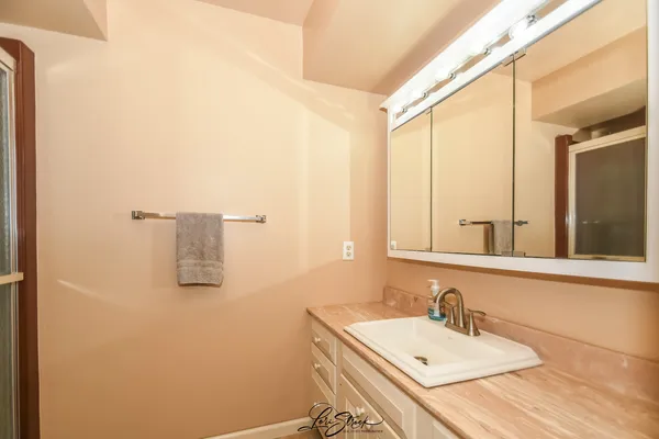a bathroom with a shower and a glass door