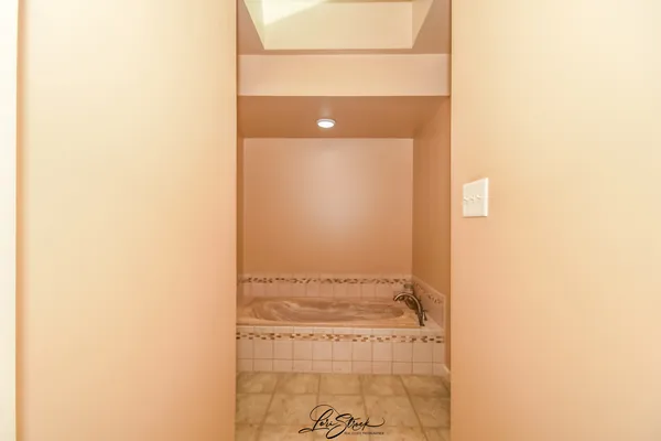 a spacious bathroom with a tub and shower