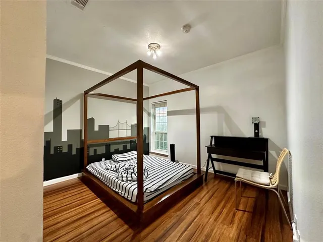 a bedroom with a bed and a television