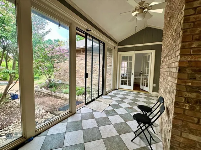 a view of a porch with a table and chairs