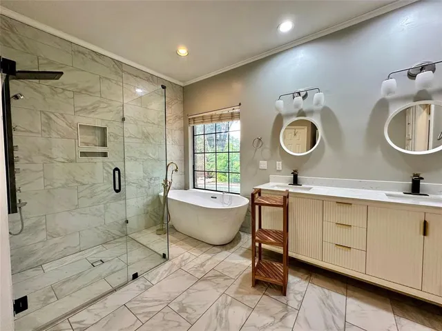 a bathroom with a double vanity sink mirror bathtub and toilet