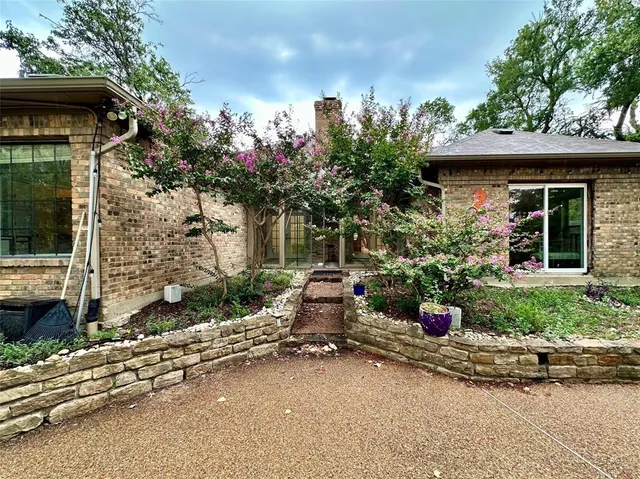 a view of a house with sitting area and garden