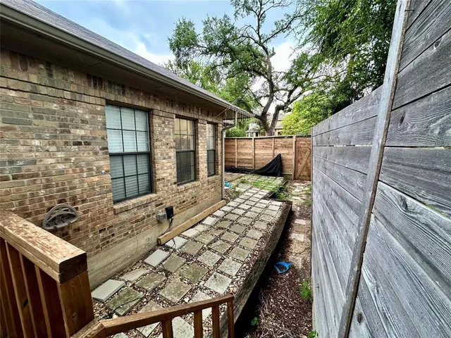 a view of balcony with wooden floor and fence