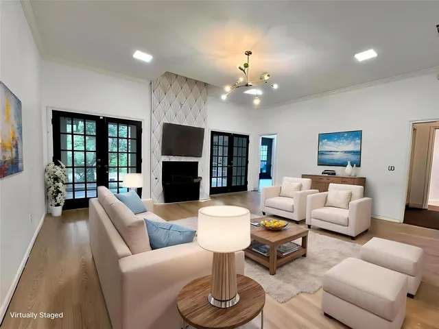 a living room with furniture a fireplace and a flat screen tv