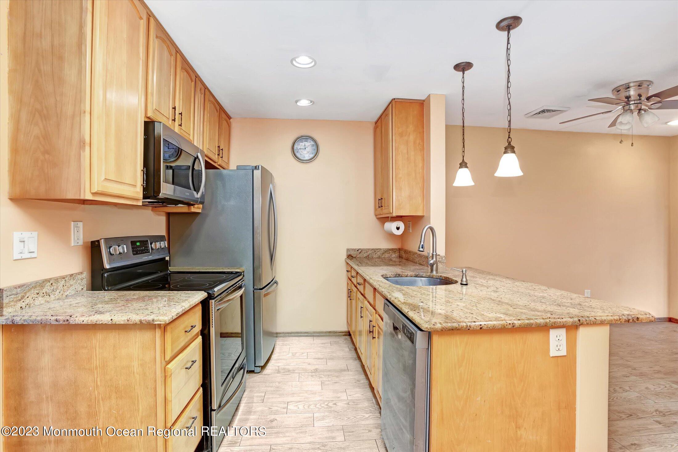 35 B Zacatin Road Freehold, NJ 07728 - Photo 8 of 35 a kitchen with stainless steel appliances granite countertop a sink a stove and a refrigerator