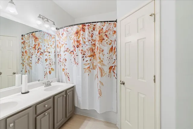 a bathroom with a granite countertop sink a toilet and a shower