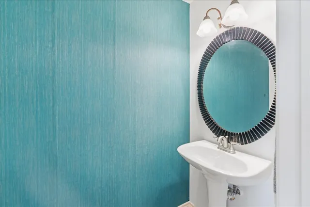 a bathroom with a sink and mirror