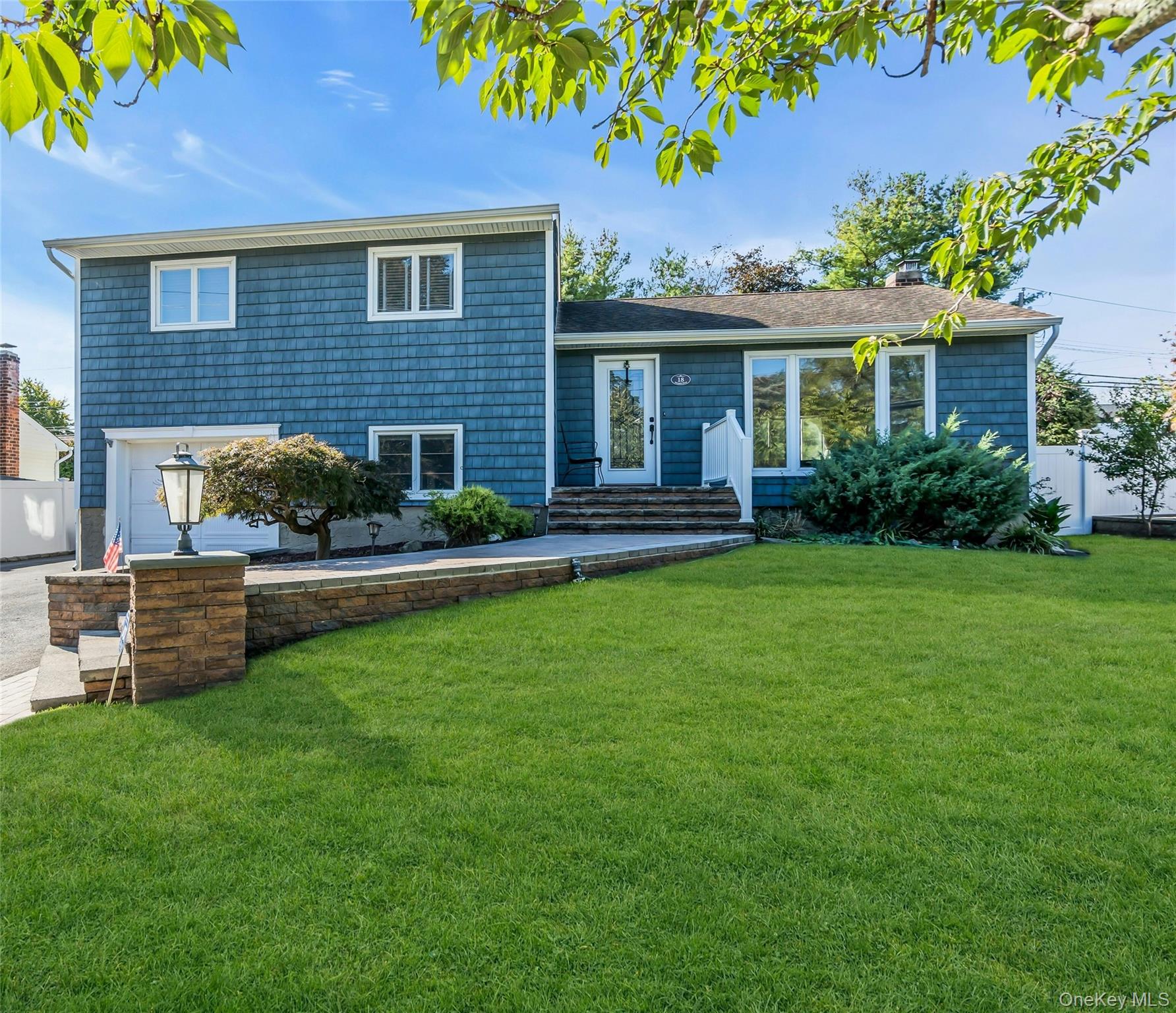 18 Haypath Road Bethpage, NY 11714 - Photo 1 of 1 a front view of a house with a garden and yard