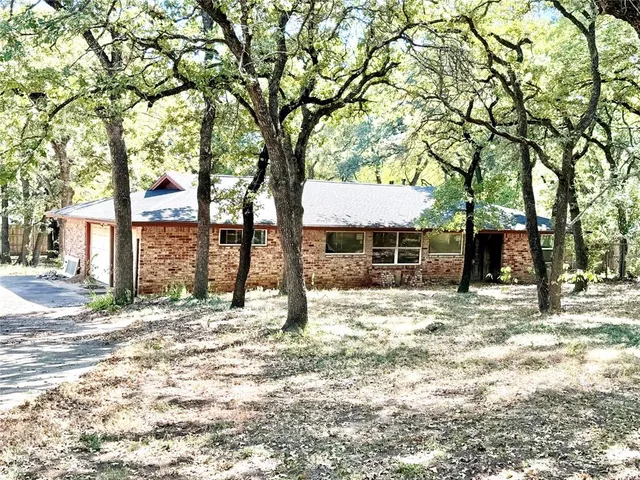 a view of a house with a tree in the background