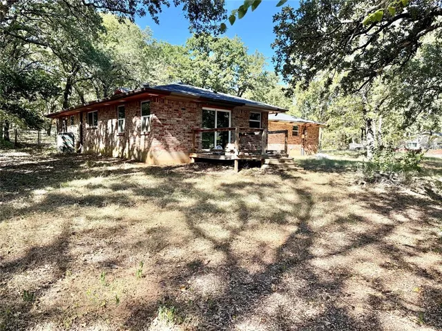 a view of a house with backyard porch and sitting area