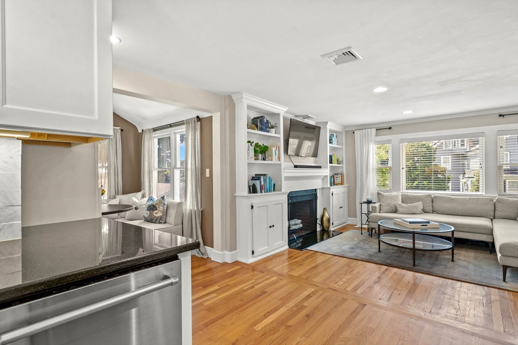 7 Leonard Circle Medford, MA 02155 - Photo 12 of 33 a living room with fireplace furniture and a floor to ceiling window