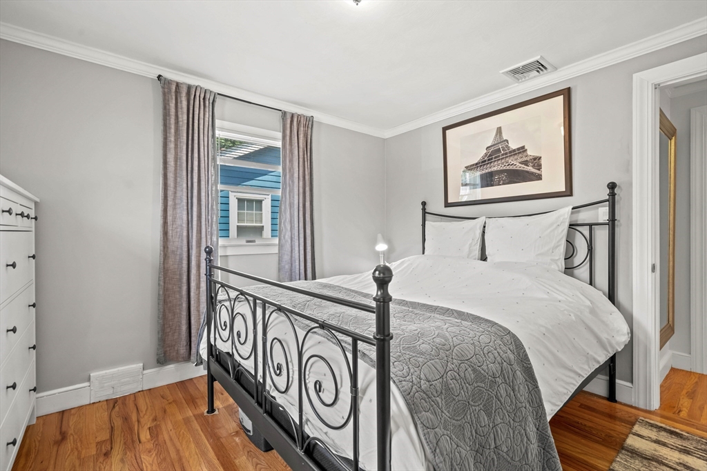 7 Leonard Circle Medford, MA 02155 - Photo 19 of 33 a bedroom with a bed and a painting on the wall