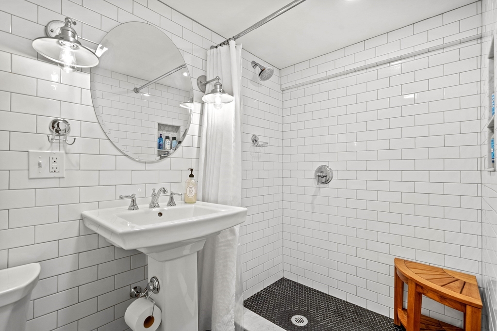 7 Leonard Circle Medford, MA 02155 - Photo 21 of 33 a bathroom with a sink shower and a mirror
