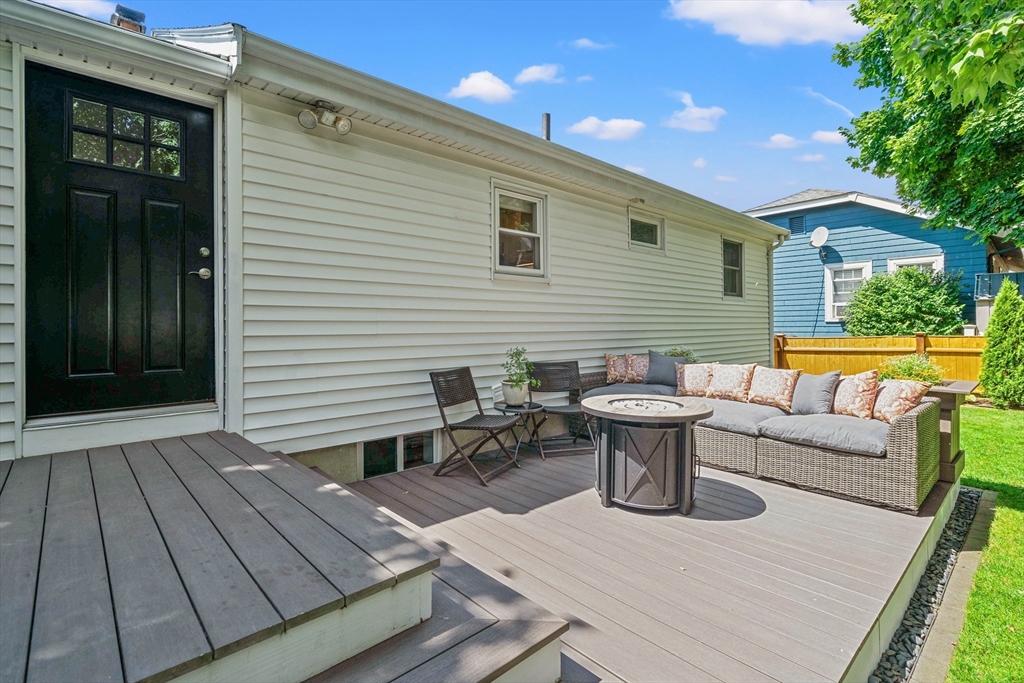 7 Leonard Circle Medford, MA 02155 - Photo 24 of 33 a view of a patio with couches and table and chairs with wooden floor
