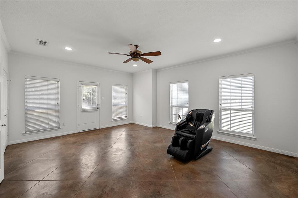 3696 Old Lorena Road Lorena, TX 76655 - Photo 23 of 27 Spacious room featuring rich, textured concrete flooring, multiple windows with blinds, a ceiling fan, and recessed lighting