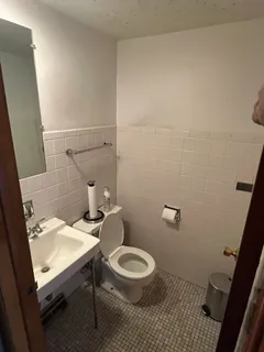 a white toilet sitting next to a small bathroom