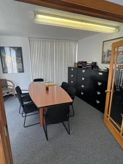 a room with furniture pool table and windows