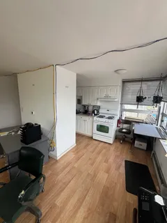 a kitchen with stainless steel appliances kitchen island granite countertop a refrigerator and a stove top oven