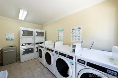 a view of washer and dryer with kitchen in the background