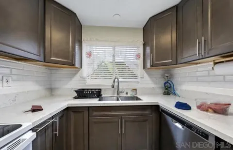 a kitchen with a sink and cabinets