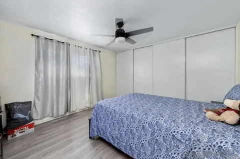 a living room with a bed furniture and a flat tv screen