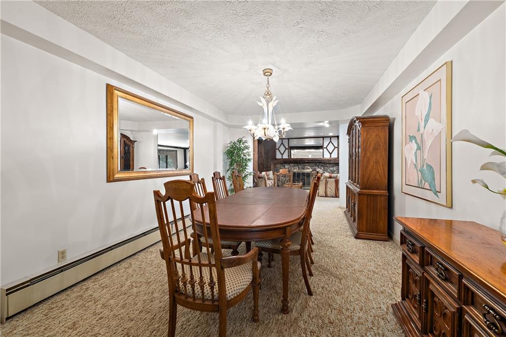 114 Pine Manor Sewickley, PA 15143 - Photo 15 of 40 a dining room with furniture a chandelier and wooden floor