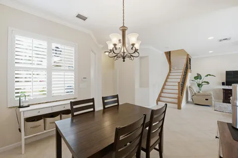 a view of a dining room with furniture and a chandelier