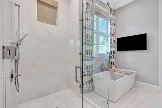 a en suite bathroom with a tub double sink and a mirror