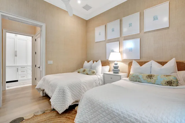 a bedroom with two beds and large window