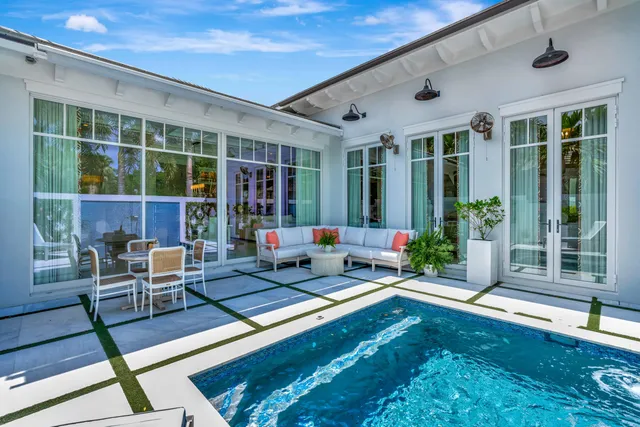 a view of a patio with table and chairs potted plants with wooden floor and fence