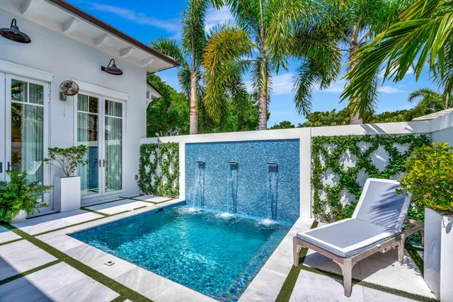 a living room with patio furniture and potted plants