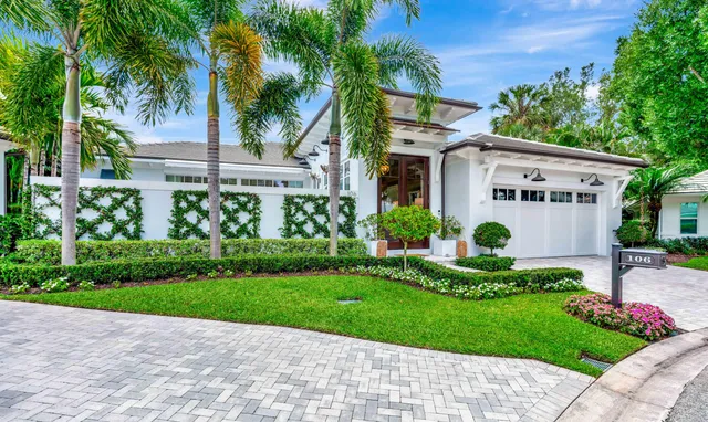 a view of a house with a small yard and plants