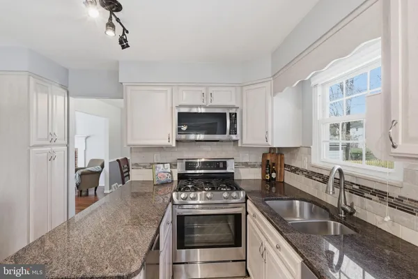 a view of a kitchen area with furniture and wooden floor