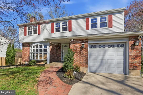 front view of a brick house with a yard