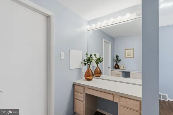 a view of a room with wooden floor and a window