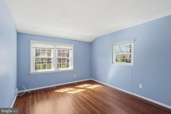 a view of a house with a small yard and a large tree