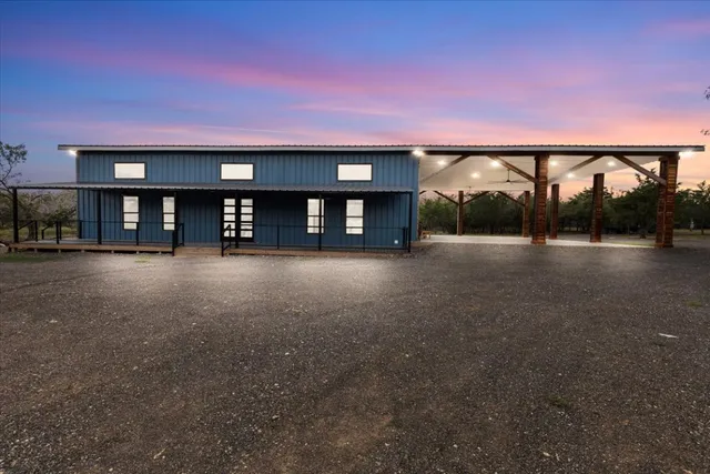 a big room with windows and pool table