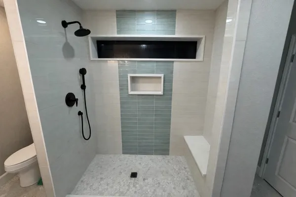 a bathroom with a shower and toilet