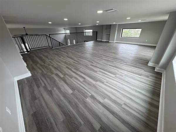 a large living room with furniture chandelier and kitchen view