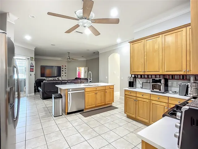 a kitchen with a sink stainless steel appliances and cabinets