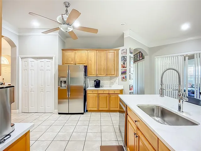 a kitchen with a sink a counter top space cabinets and stainless steel appliances