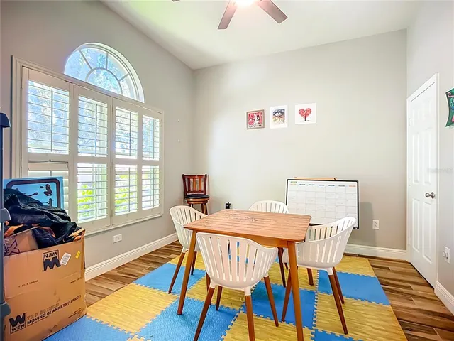 a view of a dining room with furniture a chandelier and wooden floor