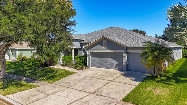 a front view of a house with a garden and yard