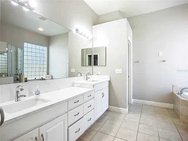 a bathroom with a double vanity sink mirror and toilet