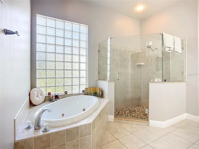 a bathroom with a tub a sink and a shower