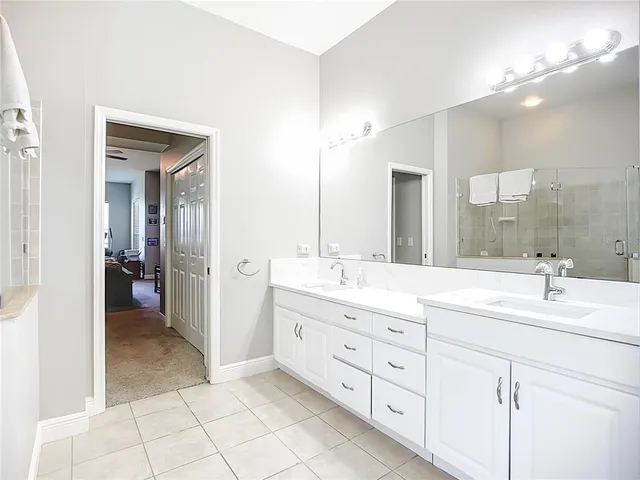 a spacious bathroom with a granite countertop sink mirror and a