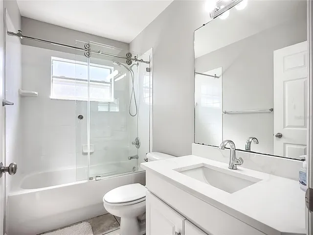 a bathroom with a sink toilet tub and shower