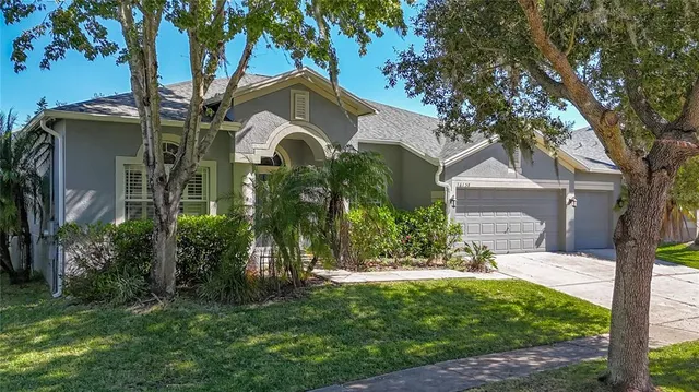 an aerial view of a house with a yard