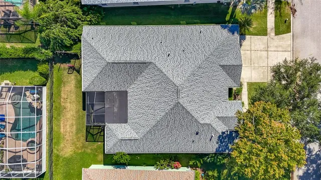 an aerial view of a house with a yard and garden