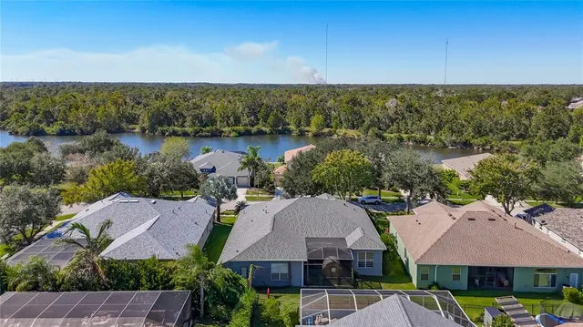 an aerial view of a house with garden space and lake view
